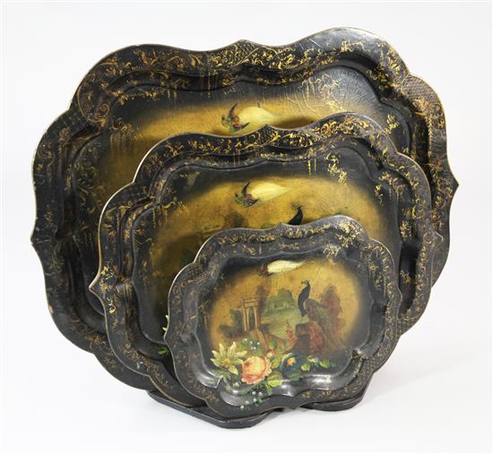 A graduated set of three Victorian papier mache trays, largest 31.5in.